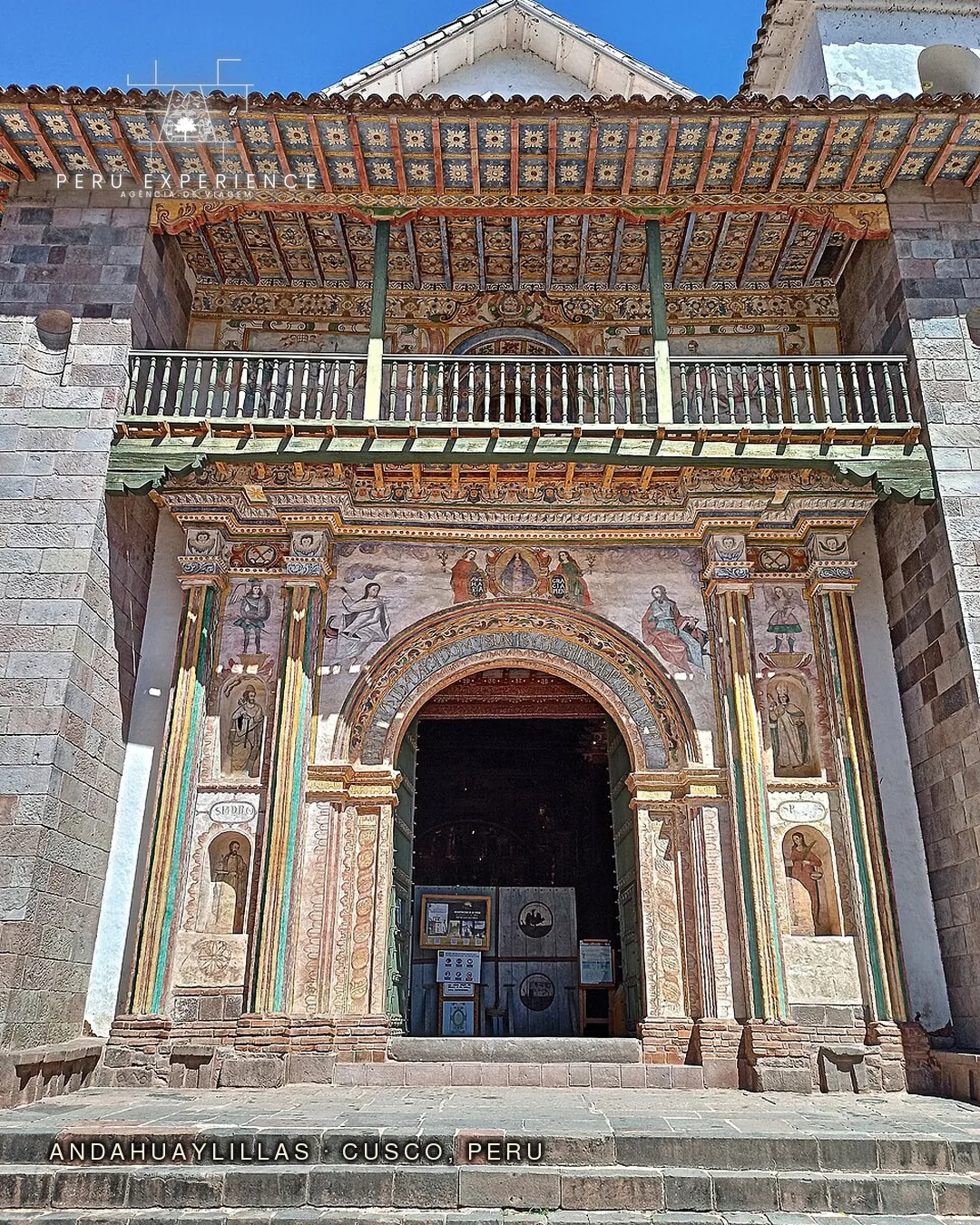 Portal policromado da Igreja de San Pedro de Andahuaylillas (século XVII), conhecida como a Capela Sistina das Américas — afrescos coloridos barrocos, sacada de madeira ornamentada e arcada decorada com pinturas religiosas em estilo cusquenho, primeira parada da rota Cusco-Puno