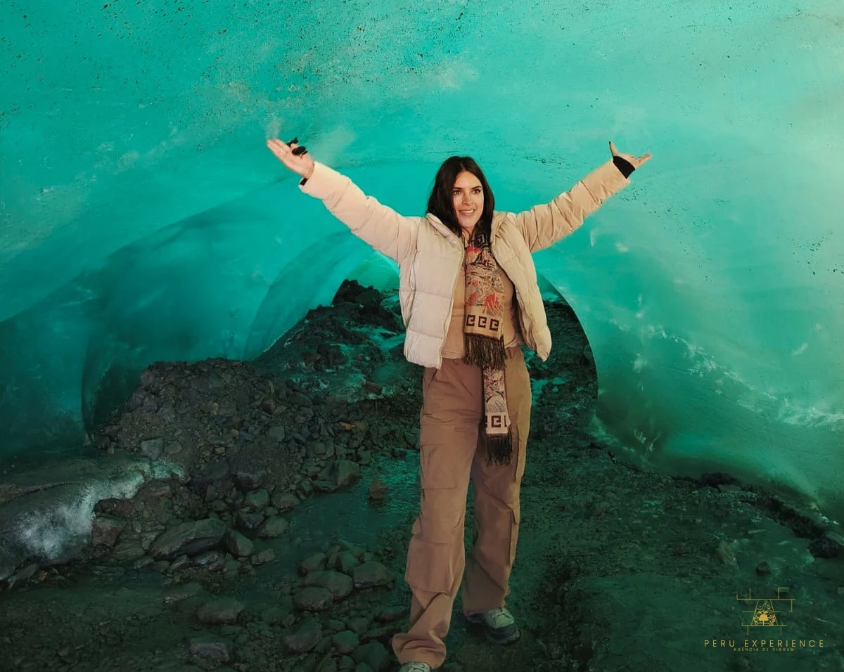 Viajante dentro da caverna de gelo turquesa do Glaciar Quelcaya com a Peru Experience